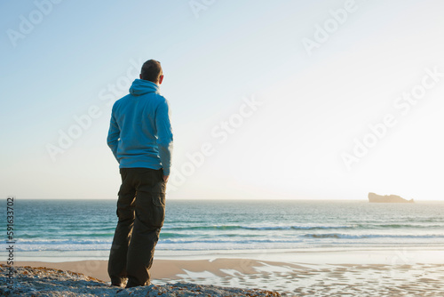 Man Looking into the Distance at the Beach, Camaret-sur-Mer, Crozon Peninsula, Finistere, Brittany, France photo