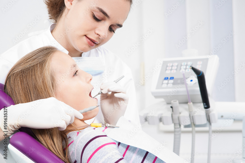 Dentist Checking Girl's Teeth during Appointment, Germany Dentist Checking Girl's Teeth during Appointment, Germany