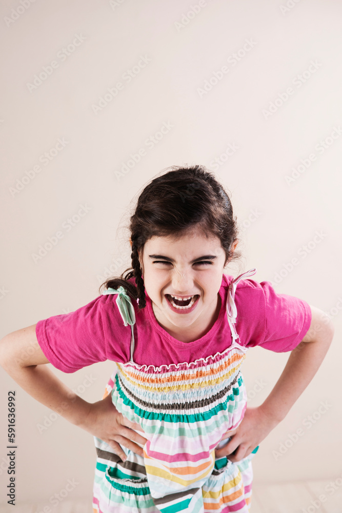 Portrait of Girl Laughing with Hands on Hips in Studio Portrait of Girl Laughing with Hands on Hips in Studio