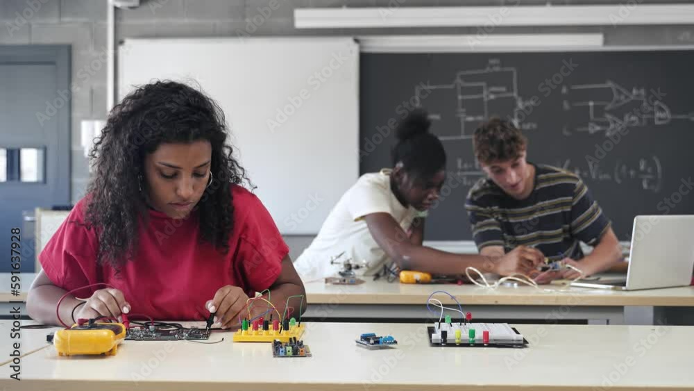 Group of students learning electronics and robotics at High School College