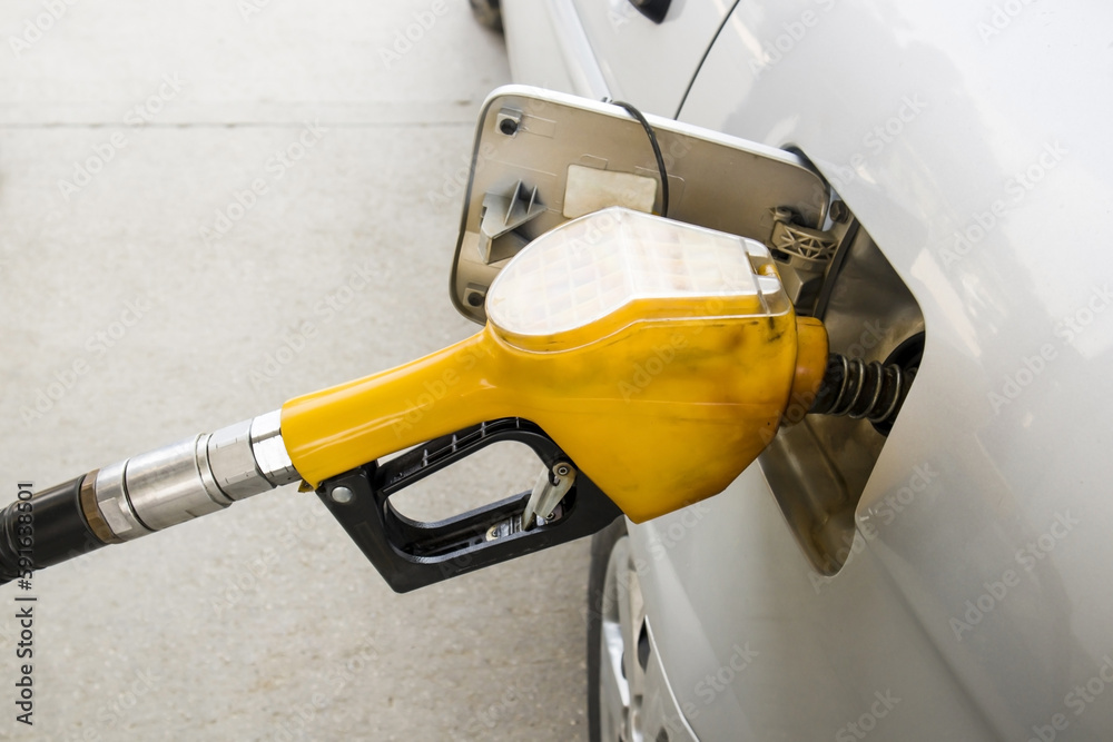 Fueling a car with a yellow pump,close up taken