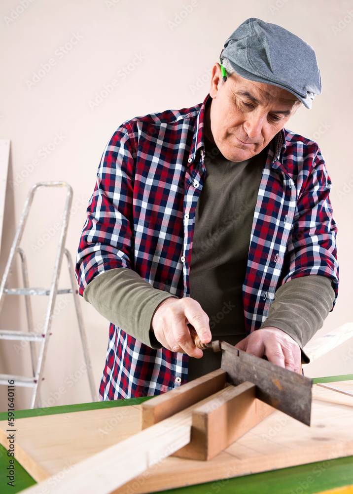 Man Cutting Lumber, Woodworking Project, in Studio Man Cutting Lumber, Woodworking Project, in Studio