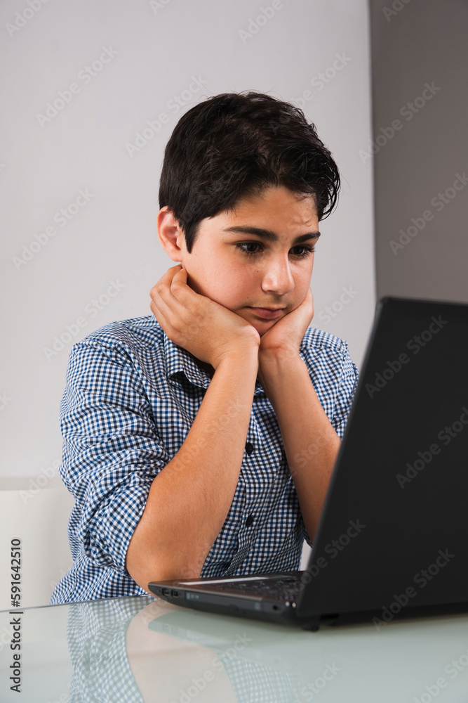 Teenage Boy using Laptop Computer, Studio Shot Teenage Boy using Laptop Computer, Studio Shot