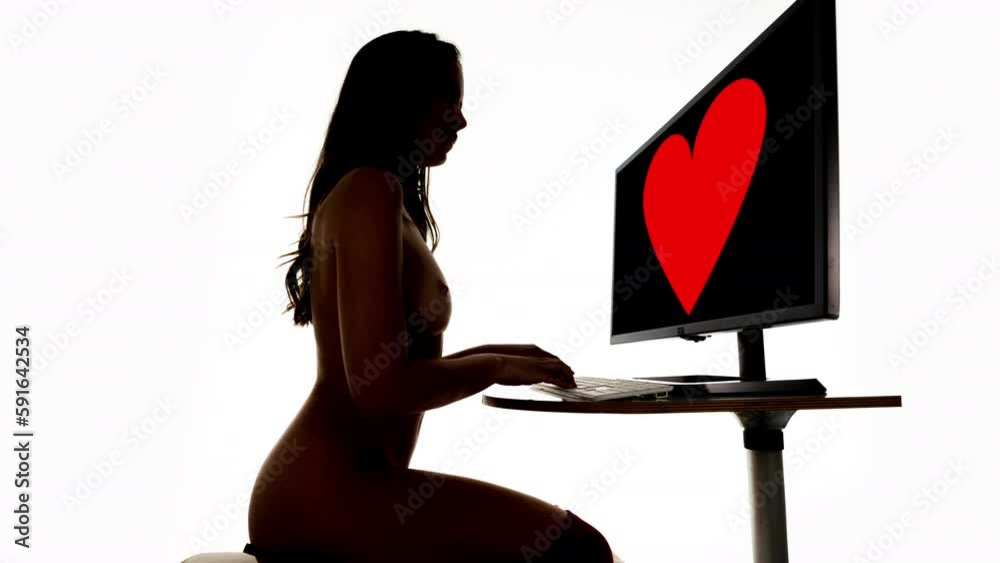 Female on a computer in silhouette 