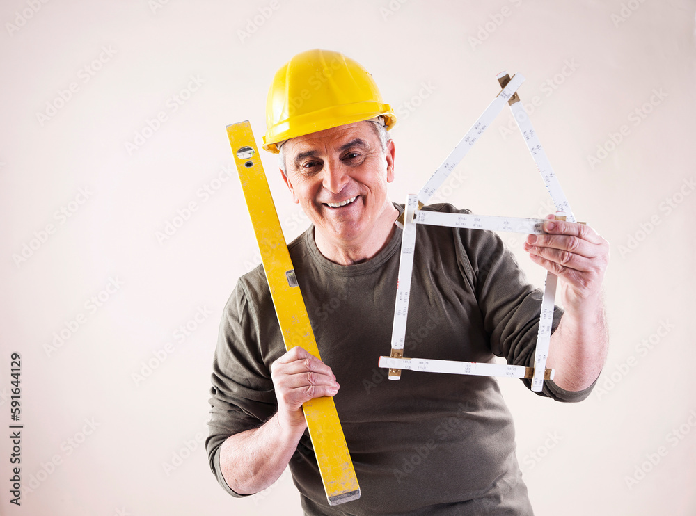Portrait of Contractor with Level and Ruler, Studio Shot