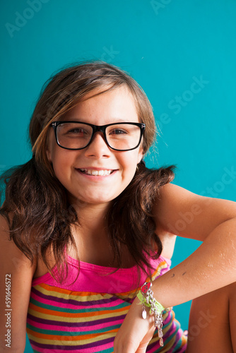 Portrait of girl wearing eyeglasses, smiling at camera, Germany photo