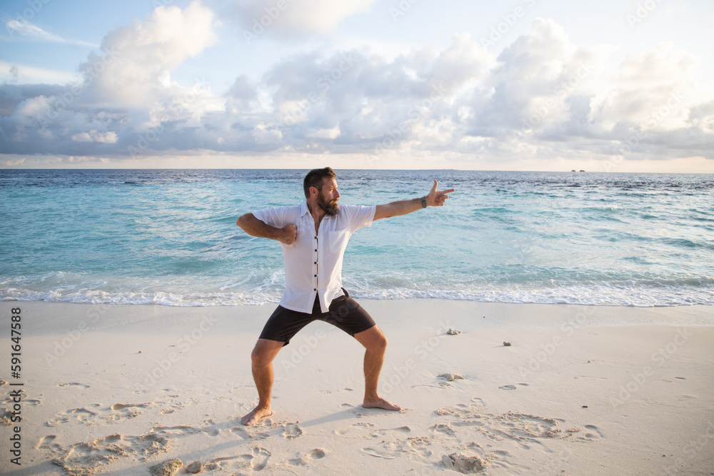 man practicing qigong by the sea