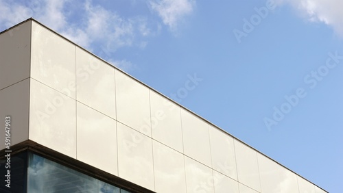cornice of modern facade against blue sky