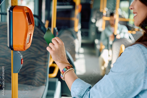 Close up of commuter scanning travel card in bus. photo