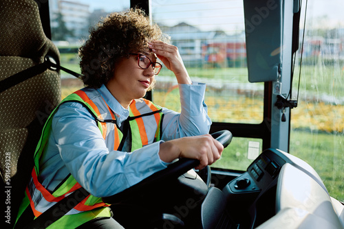 Canvastavla Female bus driver having headache while sitting behind steering wheel