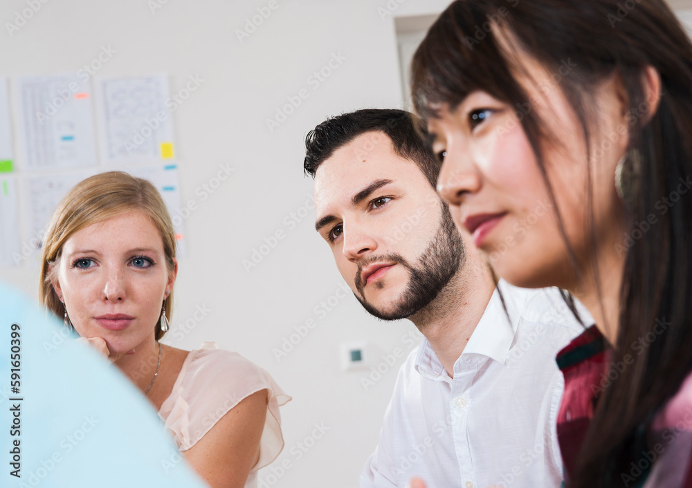 Close-up of group of young business people meeting and in discussion in office, Germany Close-up of group of young business people meeting and in discussion in office, Germany