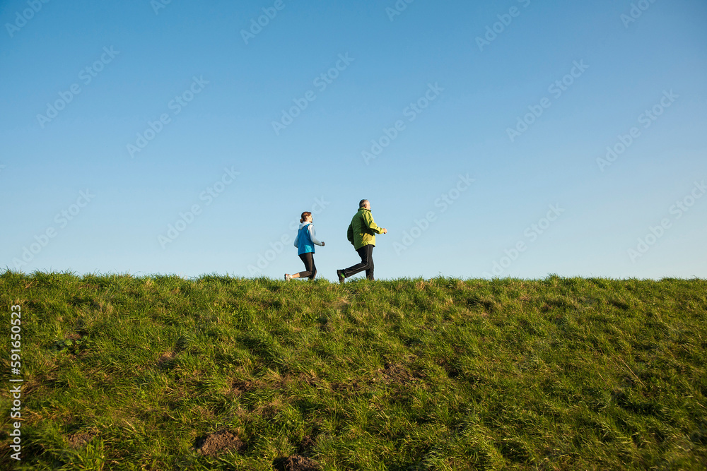 Man and Woman Jogging Outdoors, Baden-Wurttemberg, Germany Man and Woman Jogging Outdoors, Baden-Wurttemberg, Germany