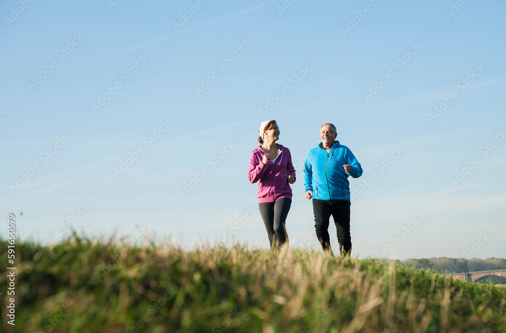 Couple Jogging Outdoors, Mannheim, Baden-Wurttemberg, Germany Couple Jogging Outdoors, Mannheim, Baden-Wurttemberg, Germany