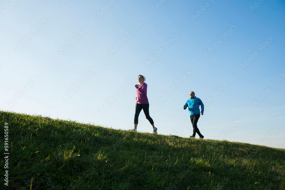 Couple Jogging Outdoors, Mannheim, Baden-Wurttemberg, Germany Couple Jogging Outdoors, Mannheim, Baden-Wurttemberg, Germany