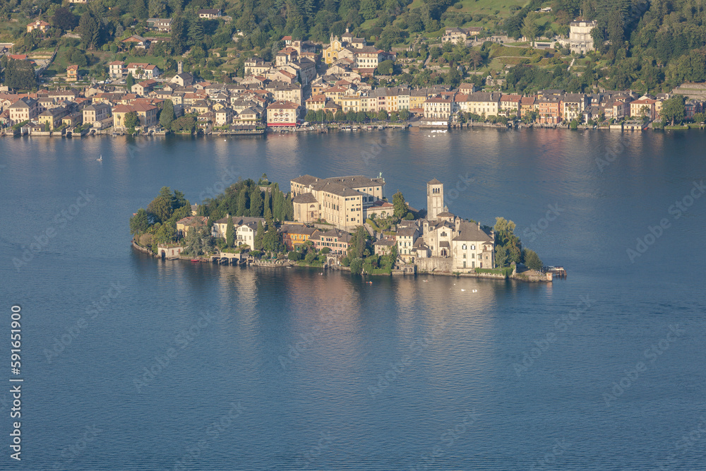 An island with ancient houses on the blue waters of an Italian lake An island with ancient houses on the blue waters of an Italian lake