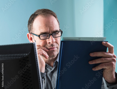 Mature Doctor Working in Doctor's Office, Mannheim, Baden-Wurttemberg, Germany