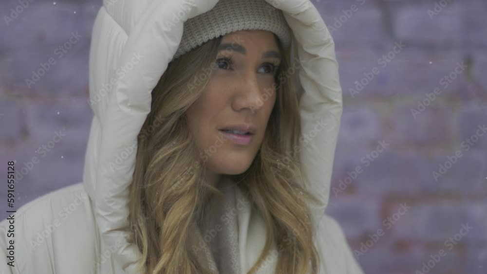 An exasperated woman stands in the snowy outdoors