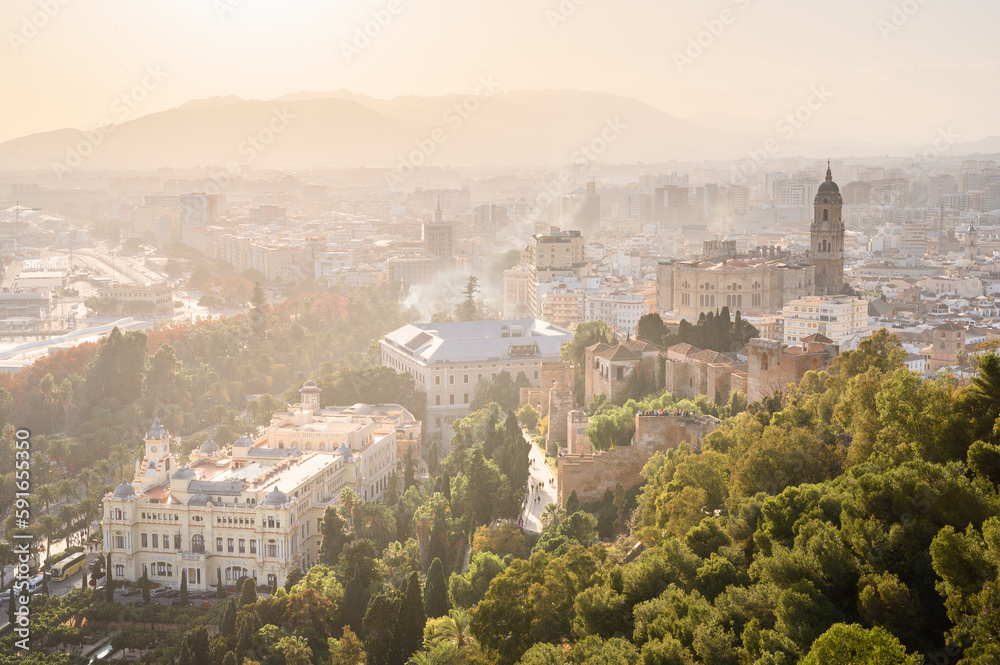 Sunset from Castillo de Gibralfaro of the city of Malaga with the Alcazaba fortress walls and Cathedral of the Incarnation, Andalusia, Spain