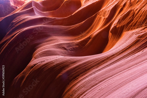 Slot canyon near Page, Arizona. The wind and water create amazing striations in the sandstone in a stunning example of erosion; Page, Arizona, United States of America photo