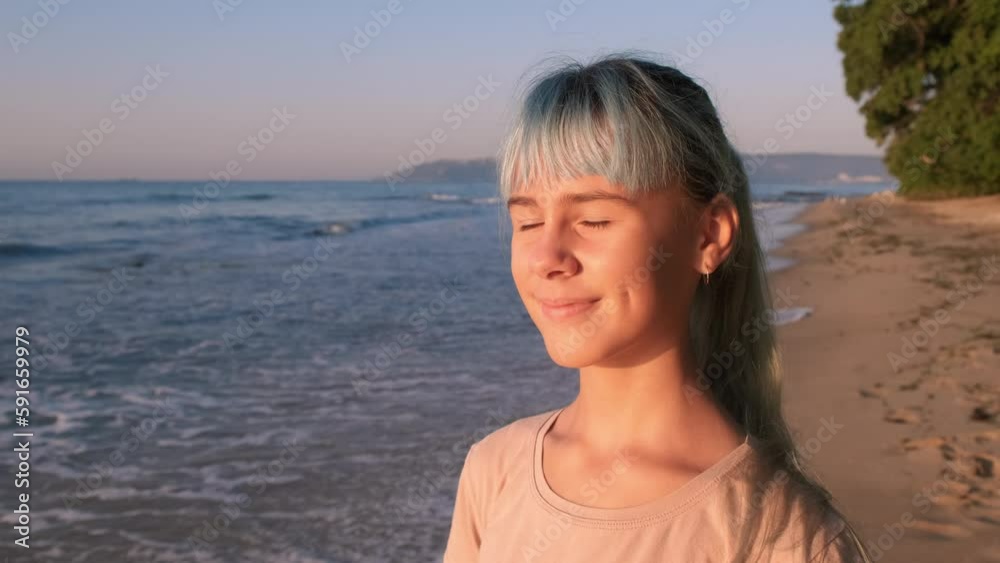 Teen smiling journey on shore. A smiling teen girl have a sea journey on the sandy shore under sun.
