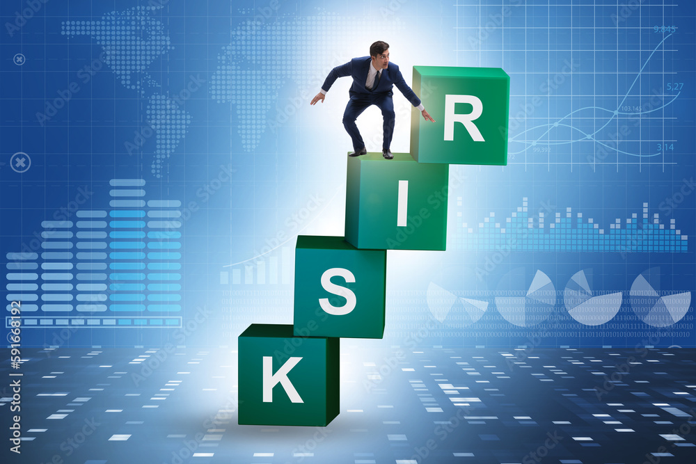 Risk management concept with businessman on cubes Risk management concept with businessman on cubes