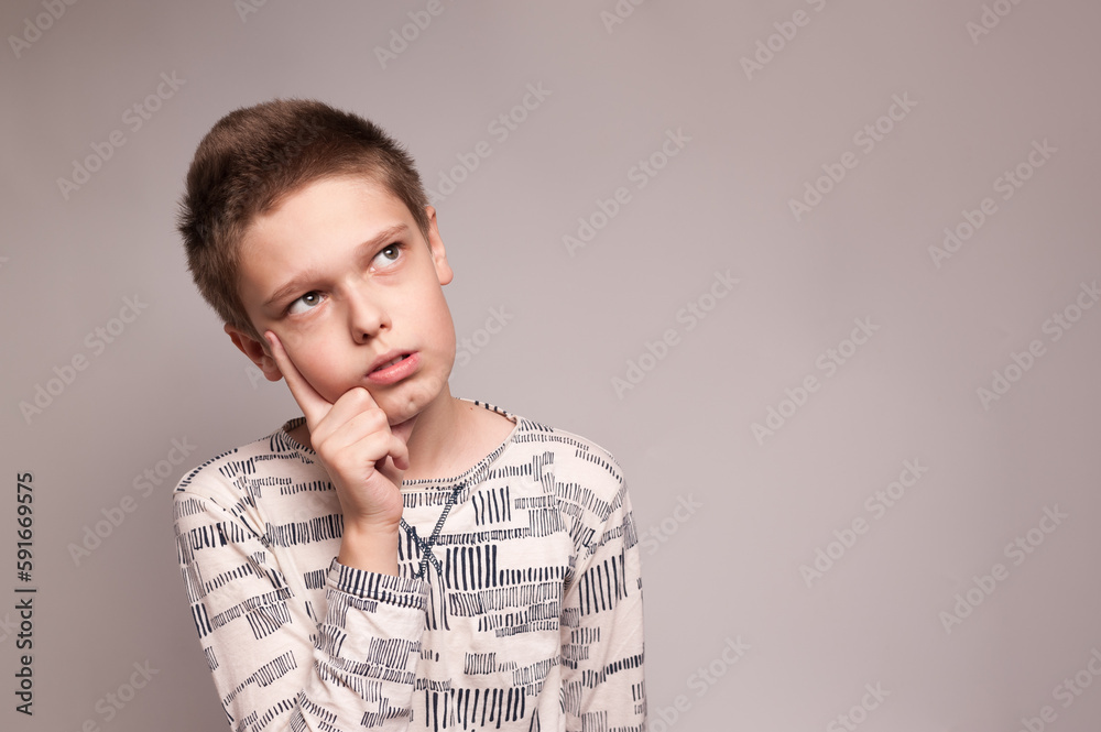 Theportrait of a boy with a thinking expression