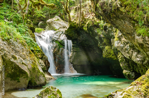 Natural long-exposure twin waterfall on Soca river in Slovenia. Velika Korita Soce