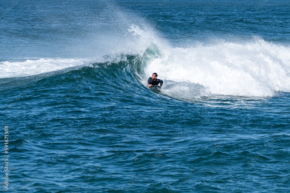 Bodyboarder surfing ocean wave