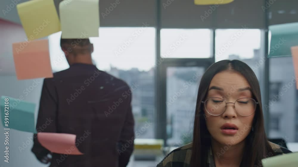 Angry man tearing sticker at office closeup. Team arguing at strategy board room Angry man tearing sticker at office closeup. Team arguing at strategy board room