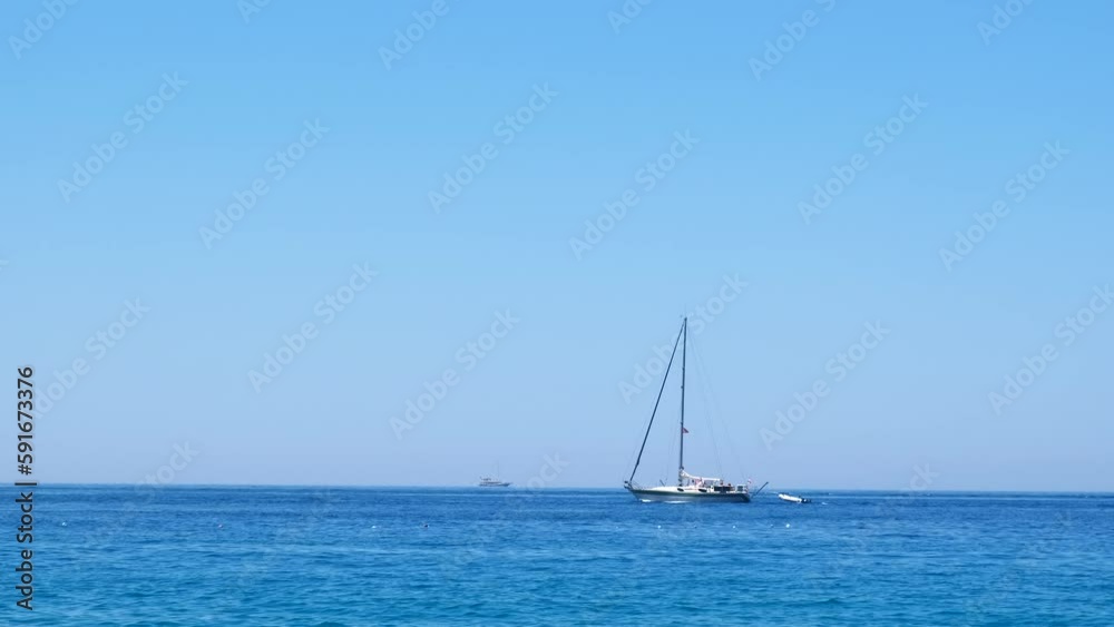 Yacht floating in lagoon at luxury resort. A pretty view of sailing yacht in the calm clear ocean under the hot sun during summer vacation. Yacht floating in lagoon at luxury resort. A pretty view of sailing yacht in the calm clear ocean under the hot sun during summer vacation.