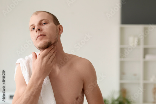 Young man before shaving in bathroom