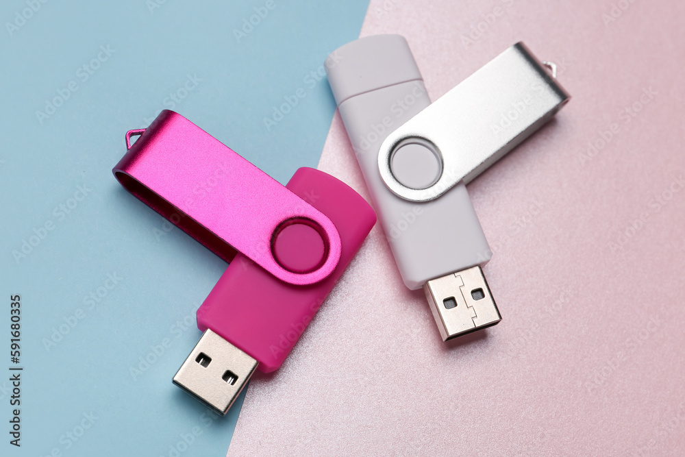 Fototapeta premium Two USB flash drives on color background