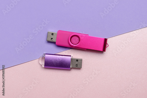 Colorful USB flash drives on color background