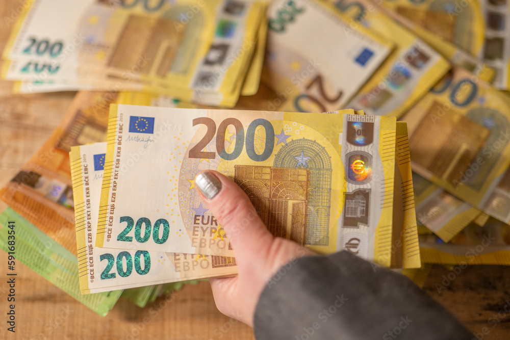  Recalculation of money.200 euro banknotes. Counting euro banknotes.Hands recalculate banknotes.Expenses and incomes in European countries.pack of money in a hand close -up.
