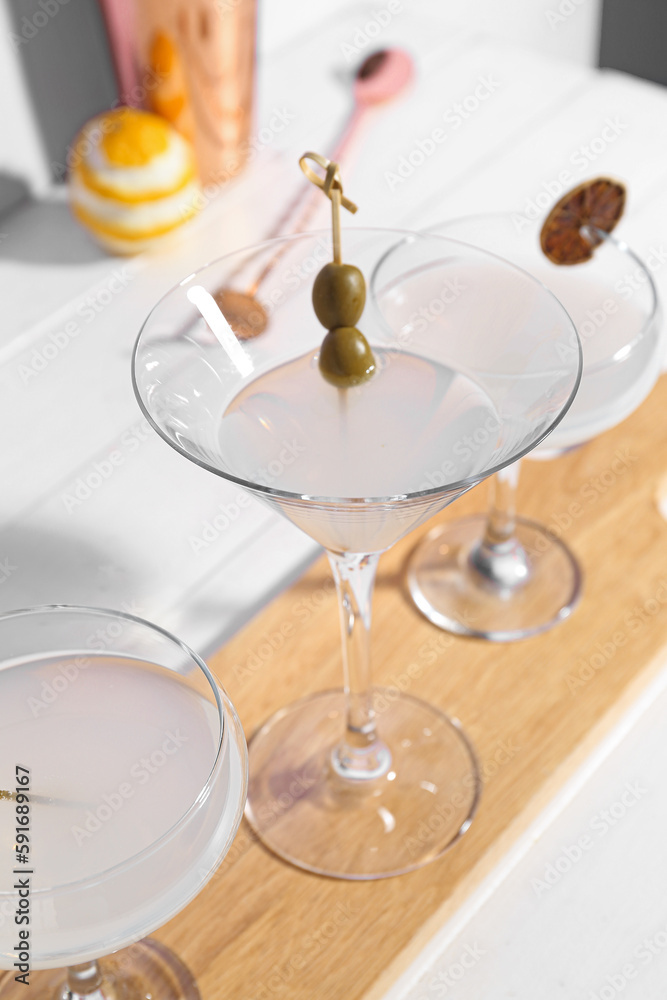 Board with glasses of martini on table Board with glasses of martini on table