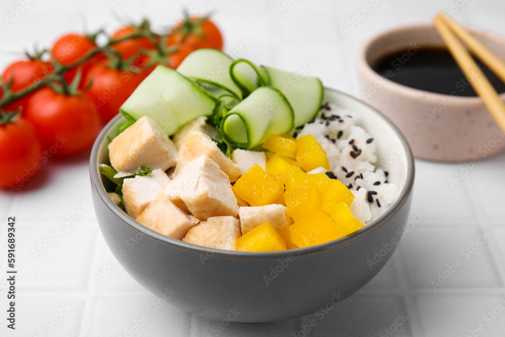 Delicious poke bowl with meat, rice and vegetables served on white table, closeup