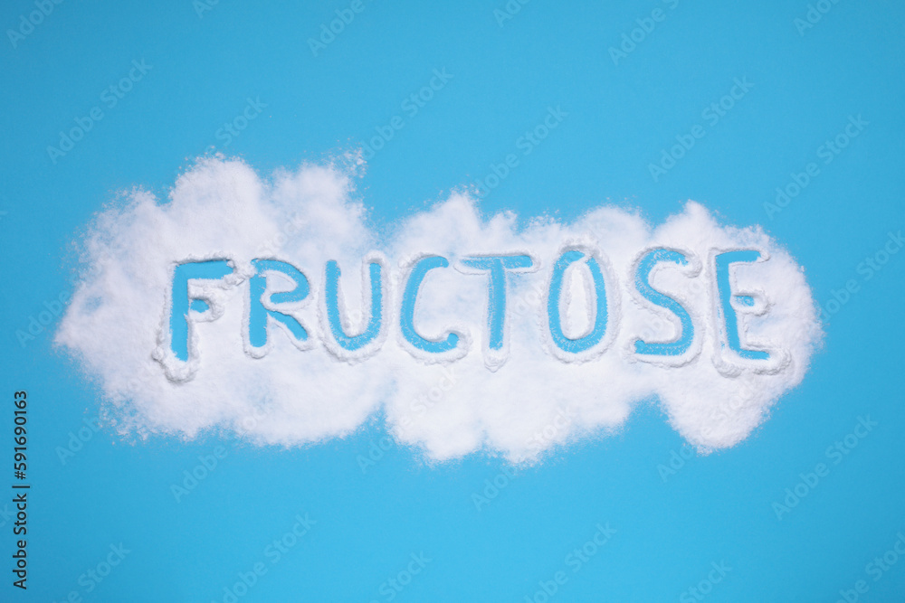 Word Fructose made of powder on light blue background, flat lay