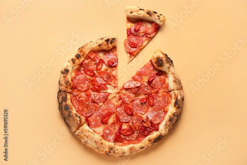 Delicious pepperoni pizza on orange background