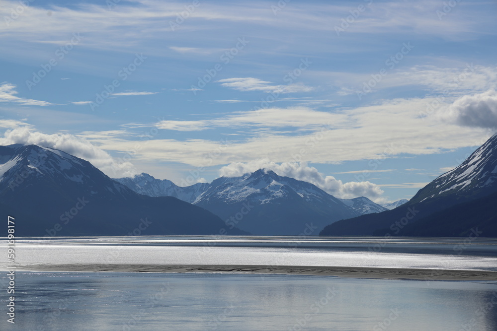 Alaska, reflection on bay water, mountains, sky