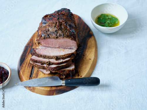 Side view slow roasted meat sliced with sauces