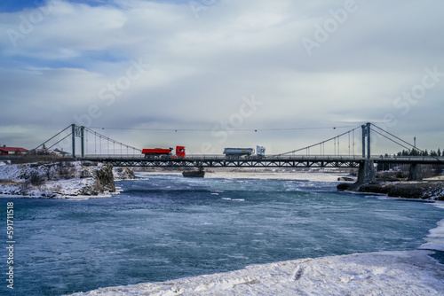 Iceland's iconic Ölfusárbrú bridge: 2-lane, 84m vehicular steel wire suspension bridge over Ölfusá river connecting Ring Road One with Selfoss Town and Southern Iceland.
