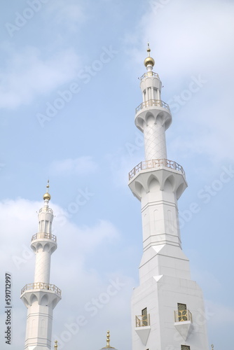 minaret of the mosque with a blue sky background