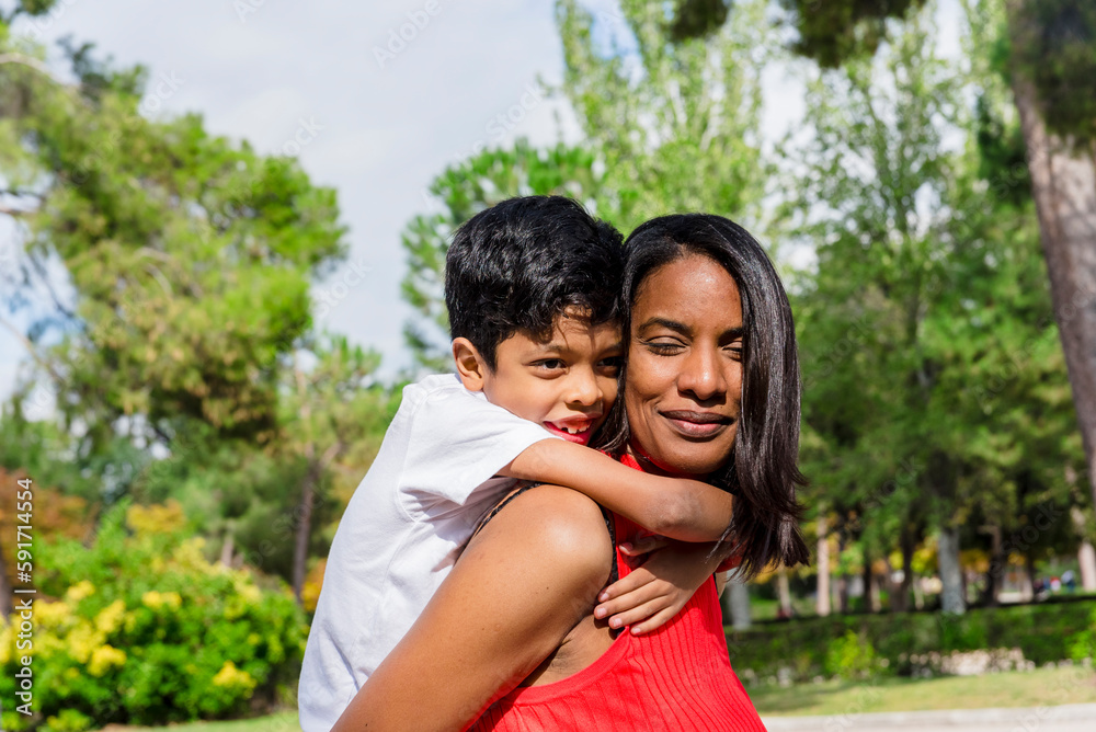Happy mother and son enjoying together outdoors in a park. Happy mother and son enjoying together outdoors in a park.