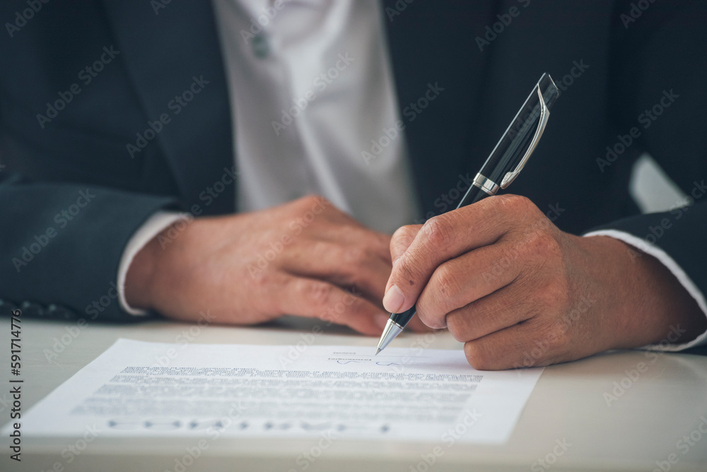 Businessman hand using pen signing on new contract starting projects in conference room. Close up business manager man hands sign contract legal document in meeting room. Business agreement concept Businessman hand using pen signing on new contract starting projects in conference room. Close up business manager man hands sign contract legal document in meeting room. Business agreement concept