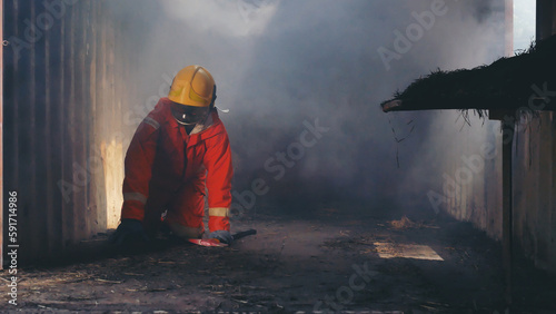 Firefighter Rescue training in fire fighting extinguisher. Firefighter fighting with flame using fire hose chemical water foam spray engine. Fireman wear hard hat, safety suit uniform for protection