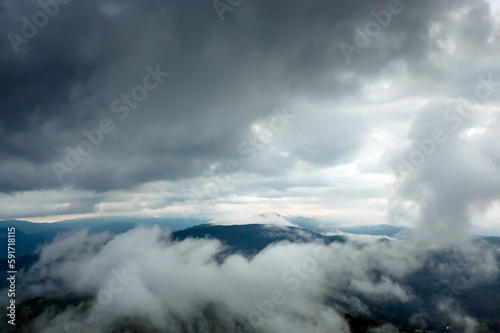 beautiful rainforest mountains landscape with big white rainy clouds