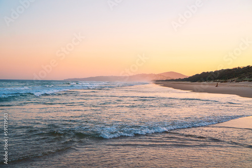 Beautiful panorama of the Peregian Beach nestled against the dunes of a pristine white sand beach with surfing breaking waves on the Sunshine Coast, Queensland, Australia.  photo