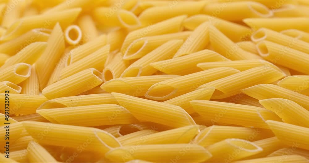 pasta backgroud - macro view of Dry Authentic Italian penne pasta backgroud - macro view of Dry Authentic Italian penne