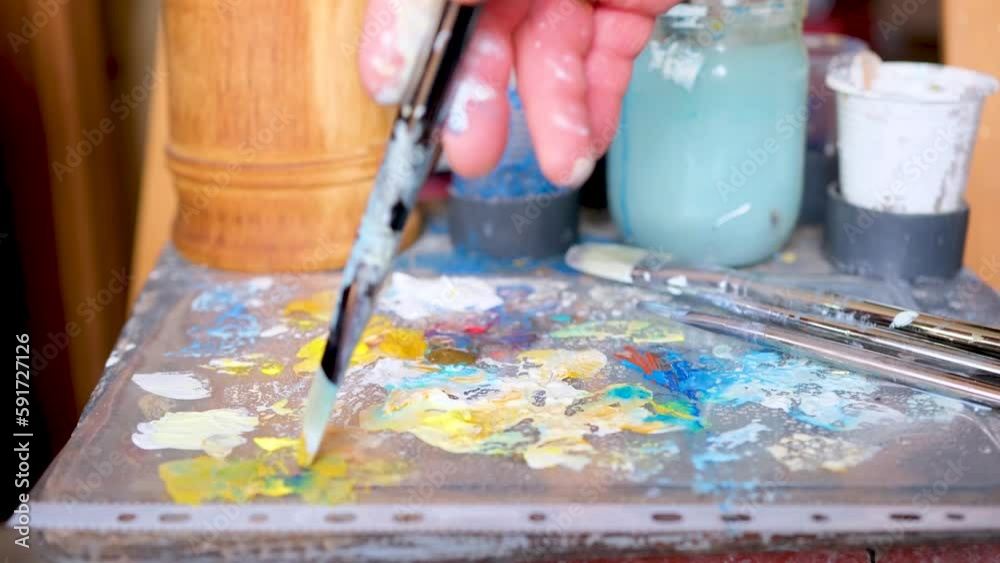 smear paint with a brush Cropped hand of female artist making yarn art on desk in workshop smear paint with a brush Cropped hand of female artist making yarn art on desk in workshop