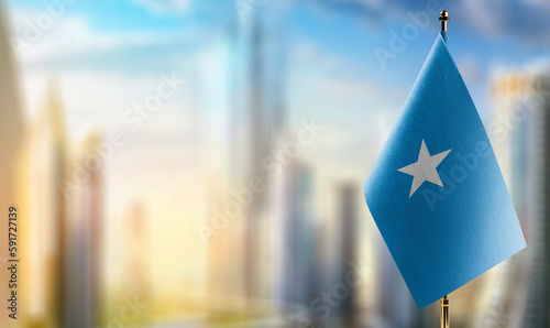 Small flags of the Somalia on an abstract blurry background